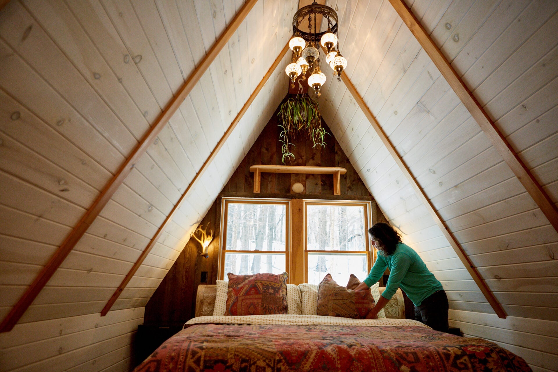 A woman fixing a bed