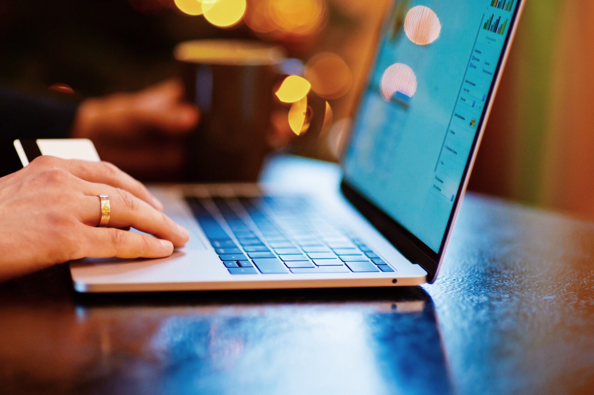 Hands typing on a laptop on a table