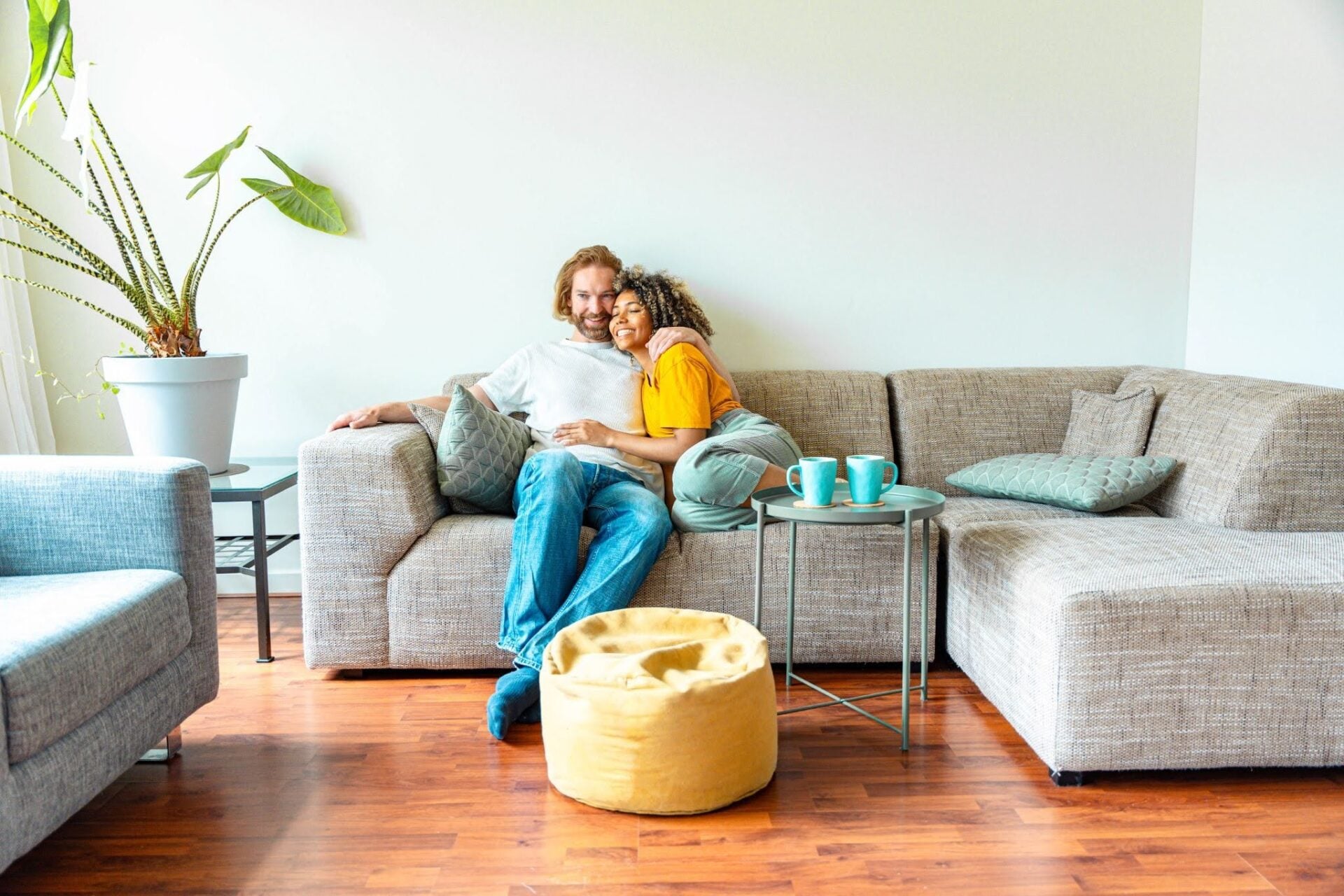 A couple cuddling on a couch