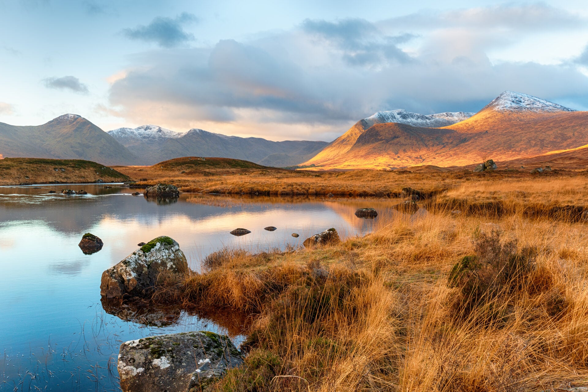 Snow capped mountains at Lochan na Stainge on Rannoch Moor at Glencoe in the Highlands of Scotland