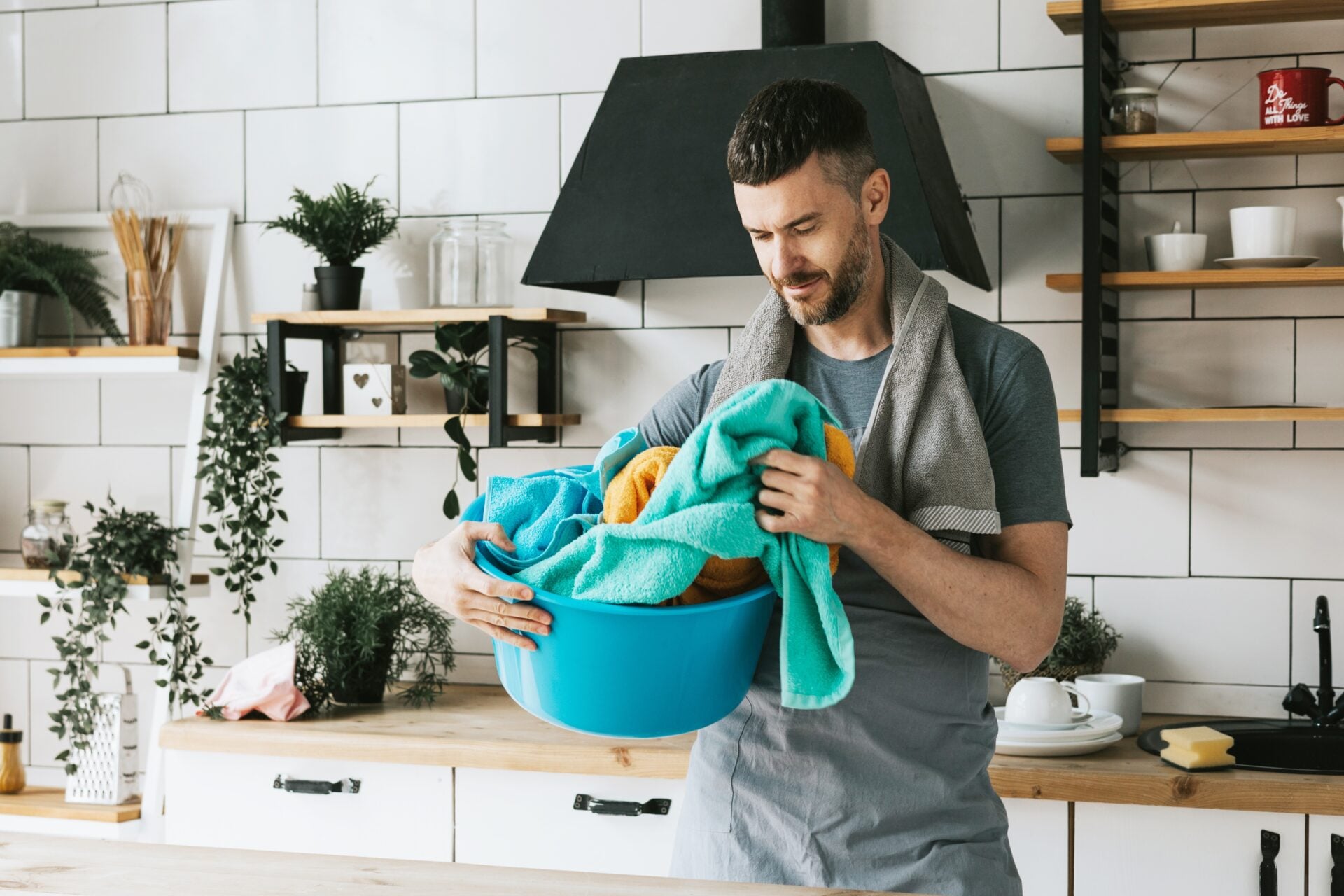Man in kitchen cleaning