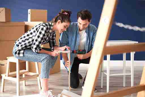 Couple installing furniture