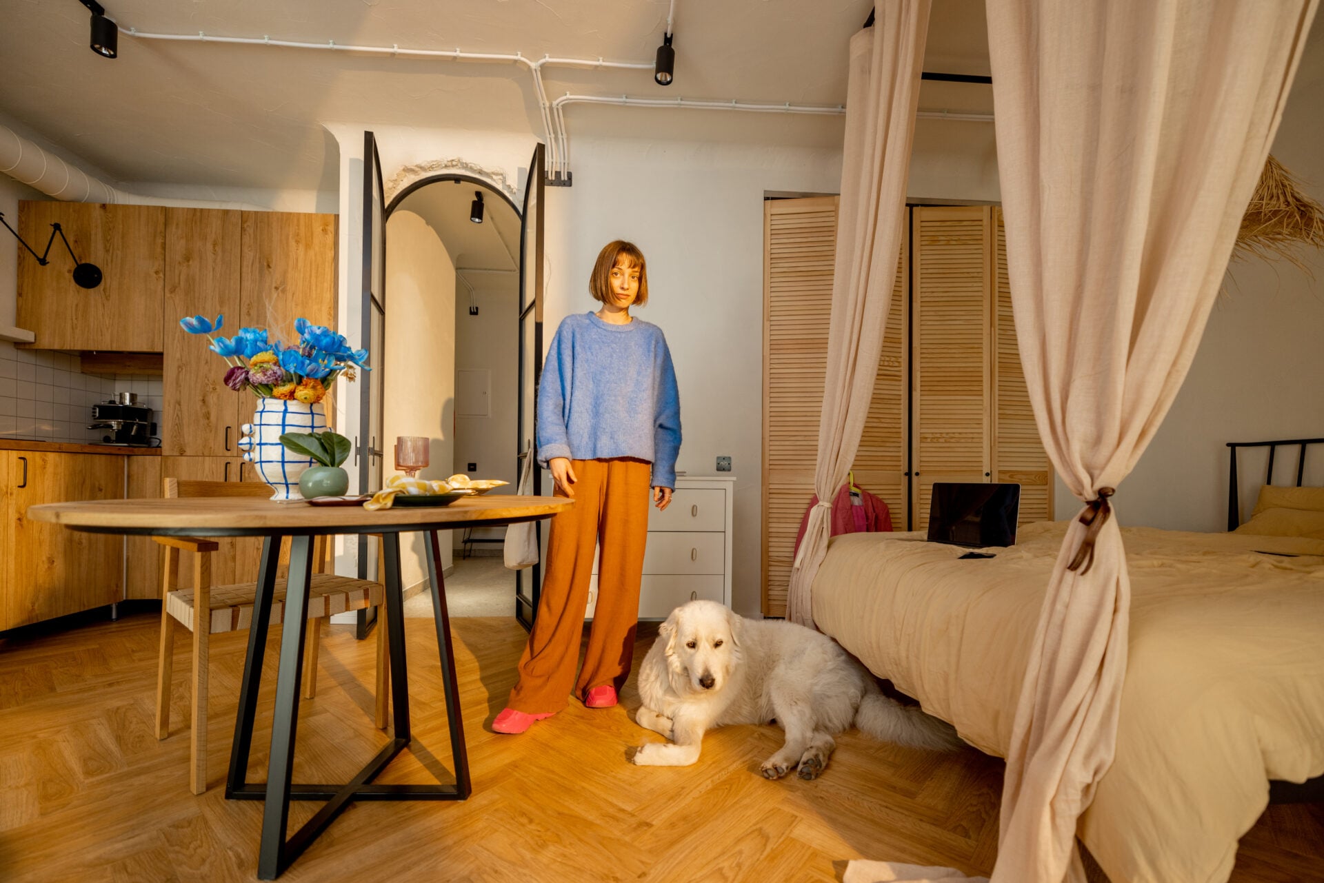 Woman and dog in stylish and modern studio apartment