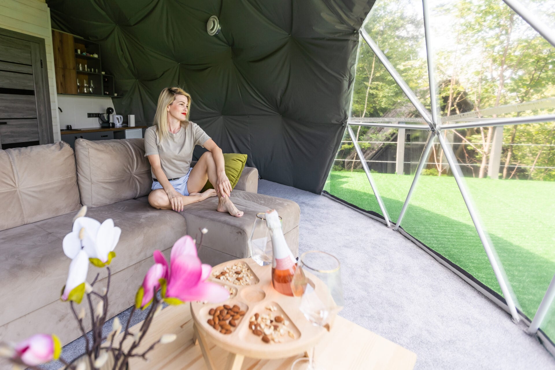 woman tourist in transparent dome hotel glamping.