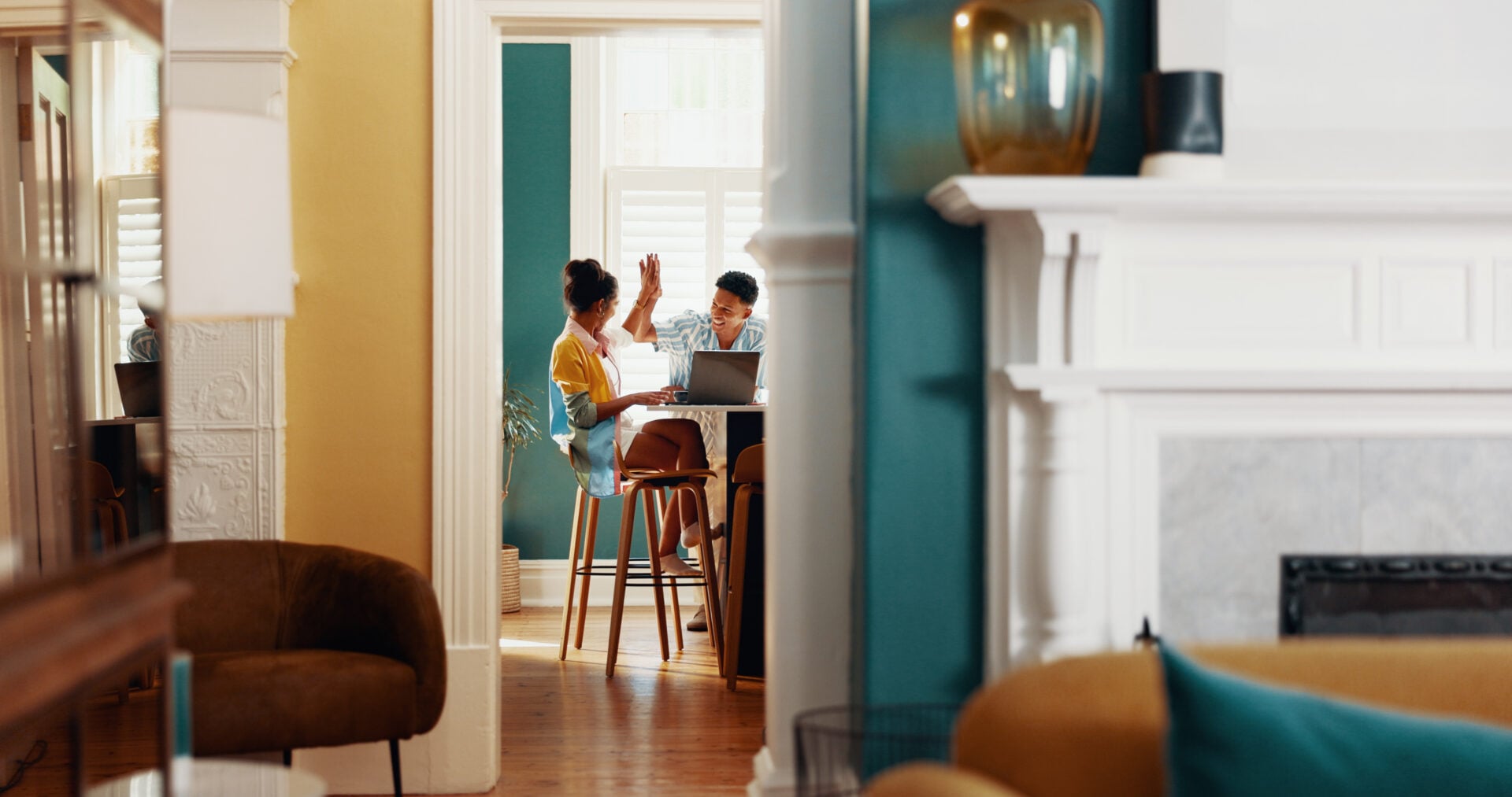 Couple, laptop and high five in home with love, study support or motivation for learning. Woman stu.
