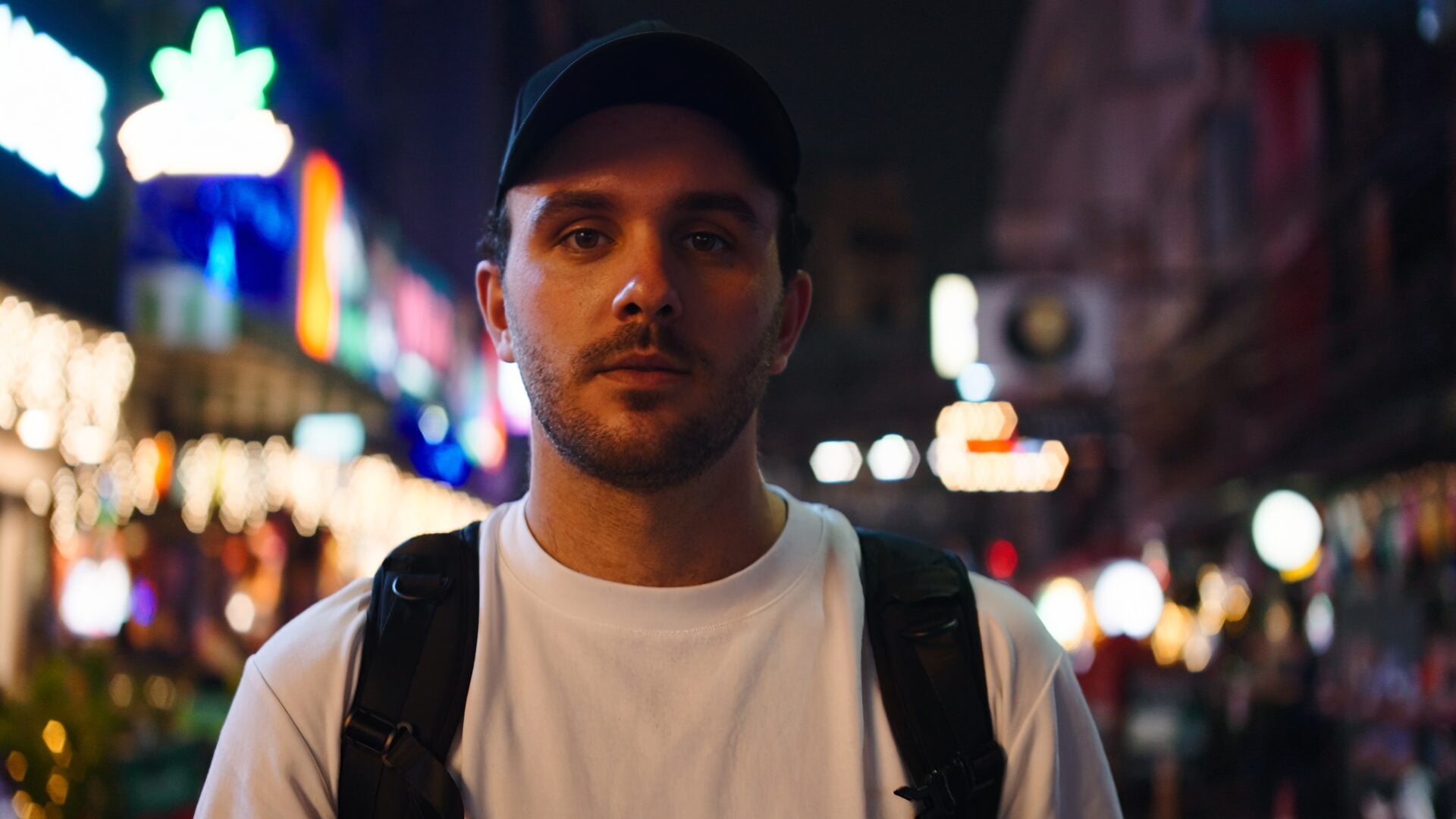 A millennial man looking directly into the camera